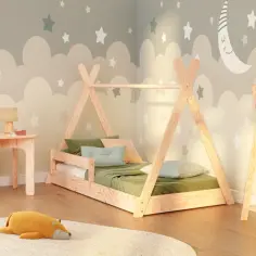 Pokój dziecięcy w stylu Montessori: łóżko tipi, stolik z krzesełkiem, pluszaki i dekoracje z chmurkami i gwiazdkami.